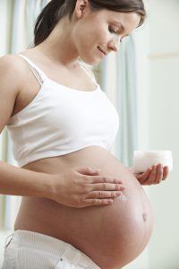 Pregnant Woman Moisturizing Belly