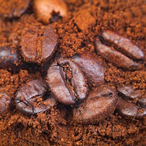 roasted coffee beans in ground coffee close up