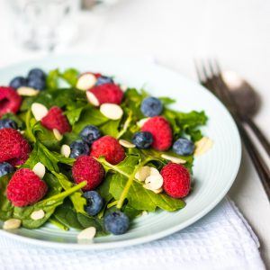 Green salad with berries and almonds