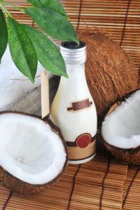 coconuts and a bottle of coconut oil
