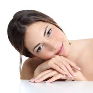 Beauty woman portrait with perfect skin and french manicure in hands
