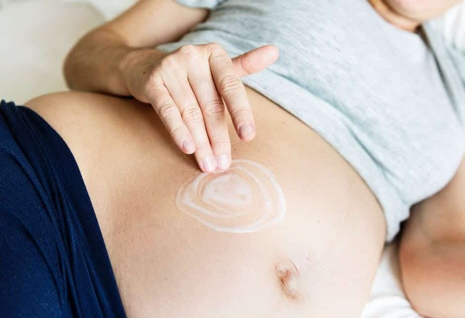a pregnant woman with stretch mark cream
