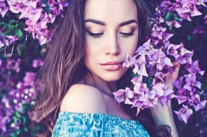 beautiful young woman surrounded by flowers