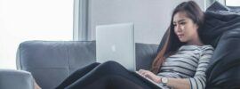 a woman on the couch with laptop