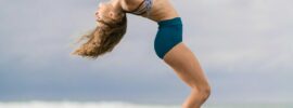 a woman stretching on the beach