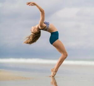 a woman stretching on the beach