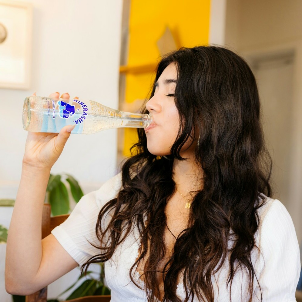 a woman drinking mineral water