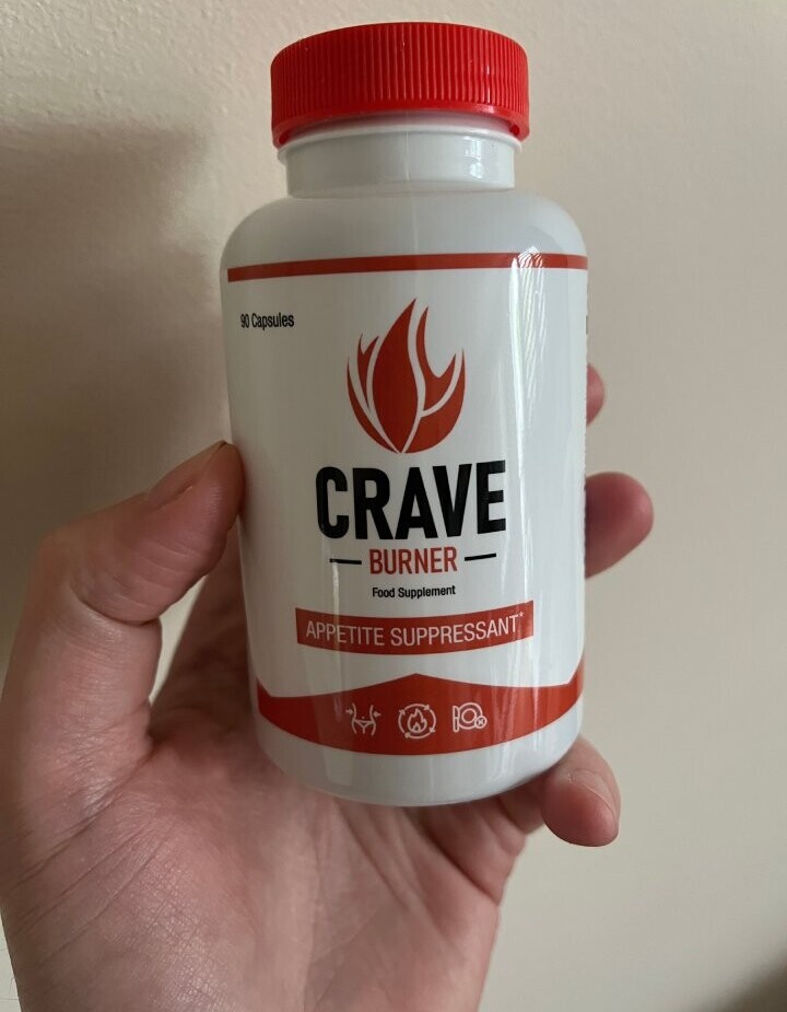 holding a bottle of crave burner pills