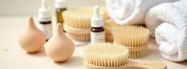 a towel, brushes and oil for lymphatic massage for cellulite